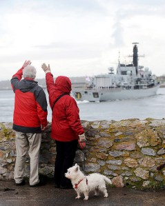 People waving to Royal Navy Ship