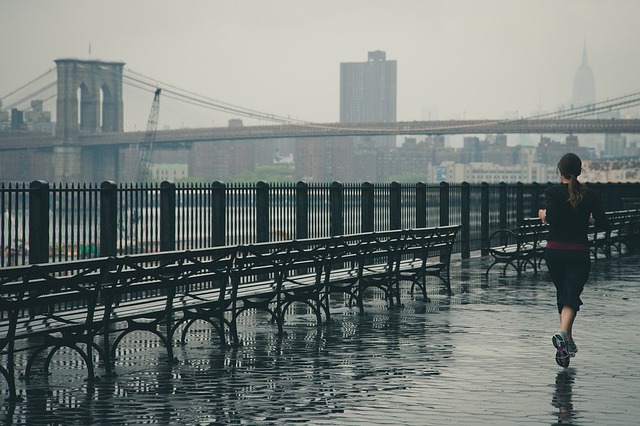 Woman running on a wet day
