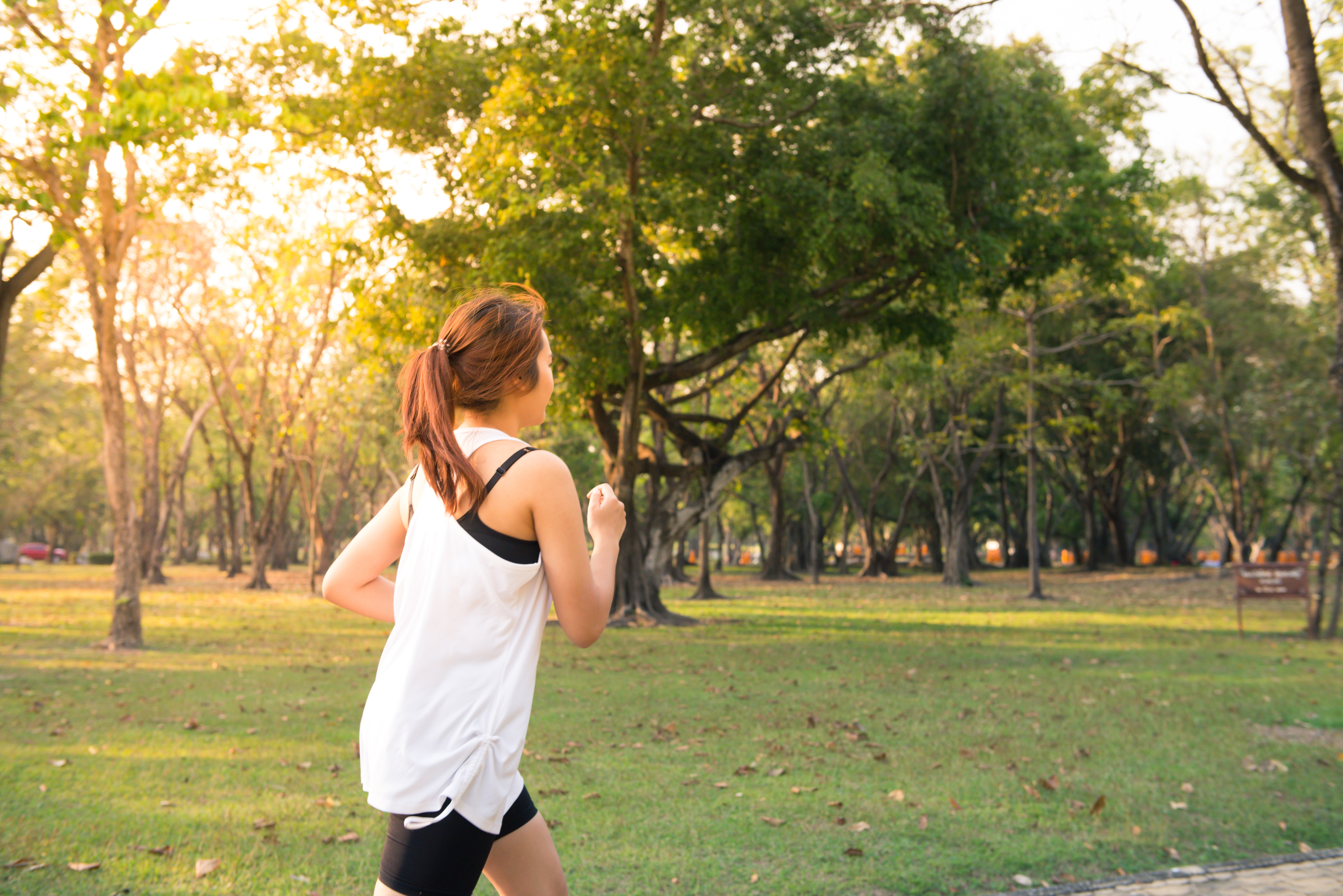 woman running in forest preserve
